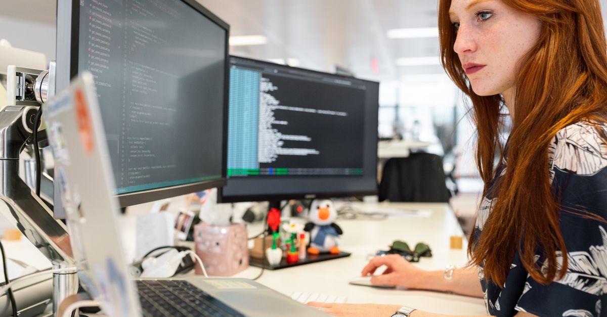 Drupal post-launch checklist: a developer reviewing a newly launched site with monitoring open.